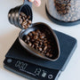 Coffee dosing tray in gebruik voor het afwegen van je koffiebonen, met koffie weegschaal en vacuum bewaarbus